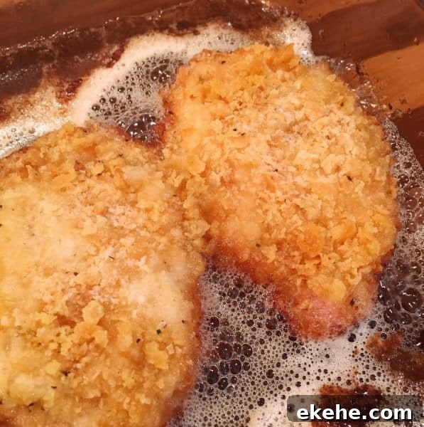 Oven Fried Butter Crumb Pork Chops in baking pan crispy brown.
