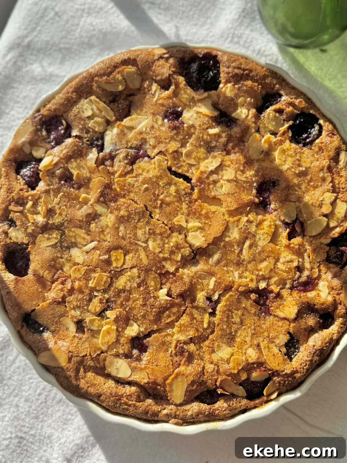 clafoutis aux cerises baked in a white pie dish.
