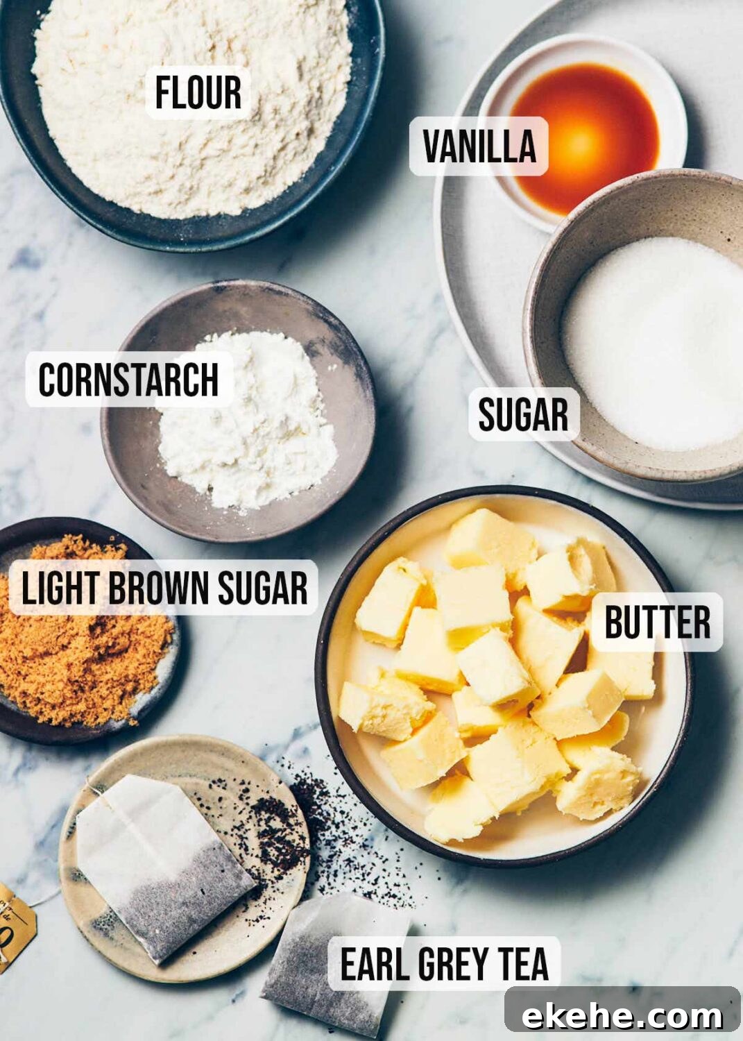 Ingredients to make earl grey shortbread (flour, vanilla, sugar, butter, earl grey tea, cornstarch)