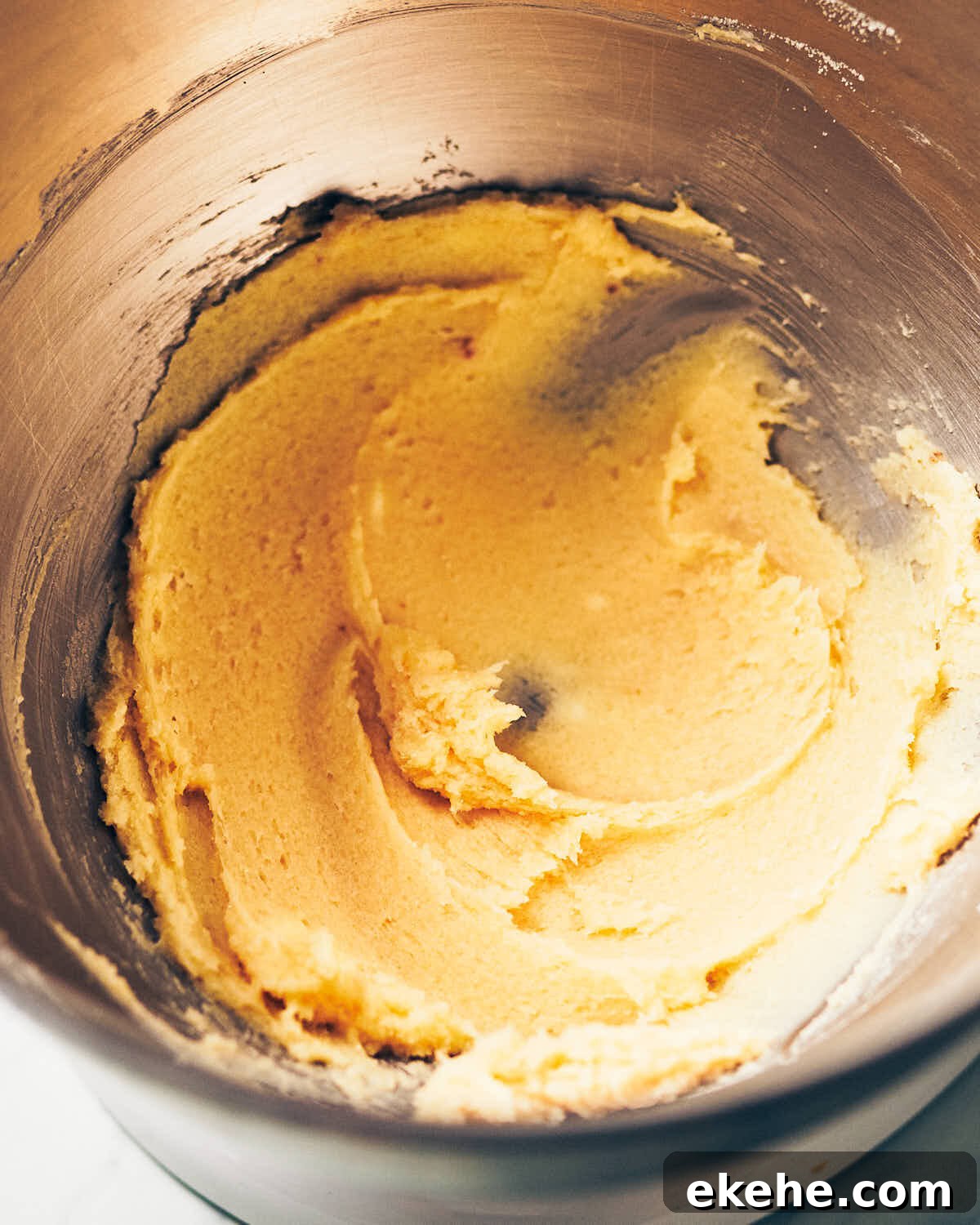 Salted butter, granulated sugar, and light brown sugar creamed together in mixing bowl for cookies