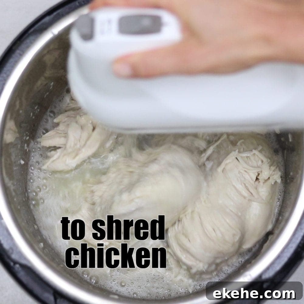 Shredding chicken with kitchen aid mixer with text that reads to shred chicken.