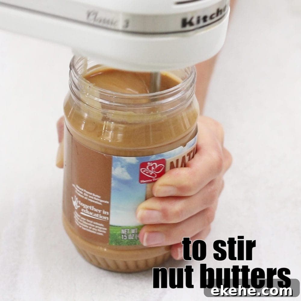 Hand Held Mixer Stirring Peanut Butter with title text that reads to stir nut butters.