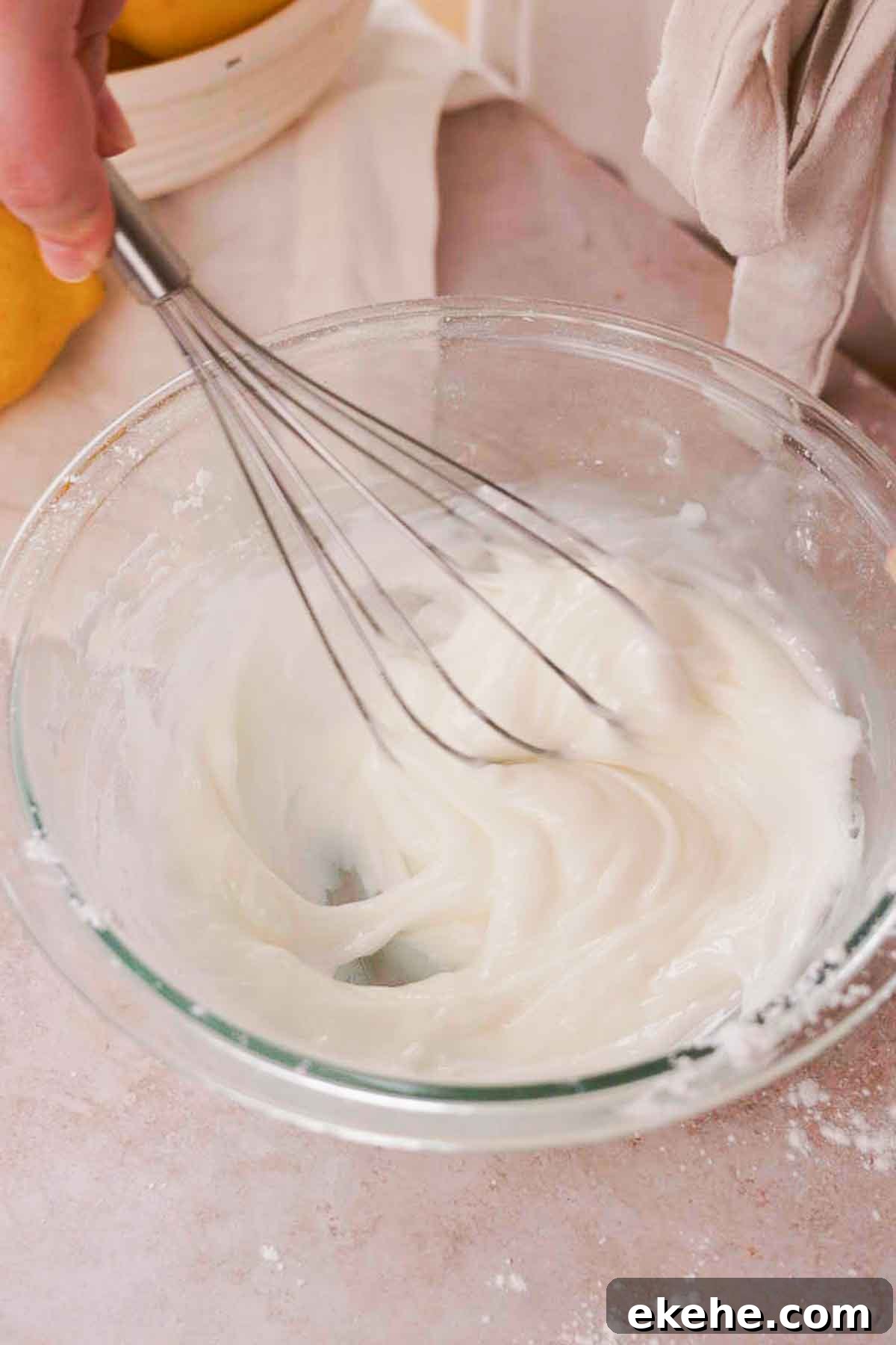 whisking together glaze for blueberry brownies