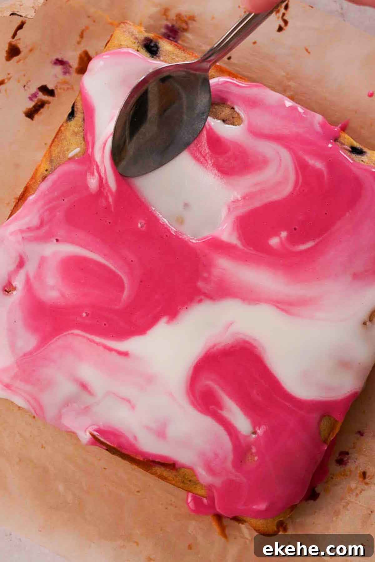 swirling purple and white glaze on blueberry brownies