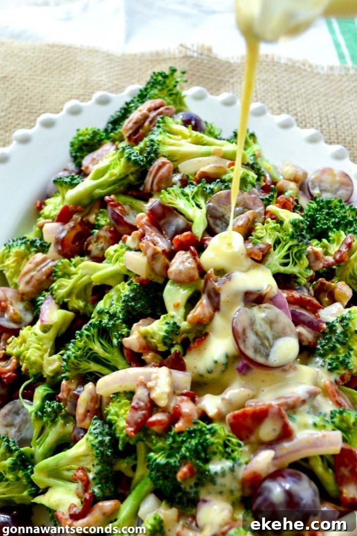 Pouring dressing over light and easy broccoli salad