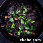 overhead shot of red wine braised short ribs, topped with parsley and ready to be served.