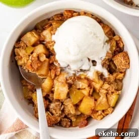 gluten free apple crisp topped with a scoop of vanilla ice cream