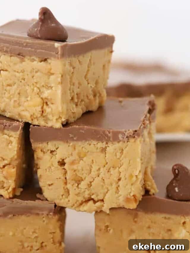 A stack of no bake peanut butter bars topped with a layer of chocolate.