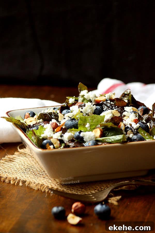 Closeup photo of salad with blueberries, feta cheese, and hazelnuts in a bowl