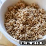 Cooked farro in white bowl.