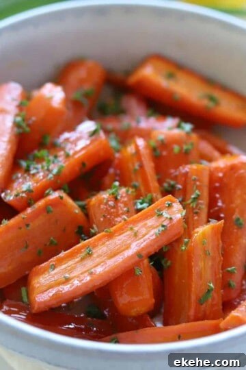 brown sugar honey glazed carrots in stoneware bowl topped with parsley