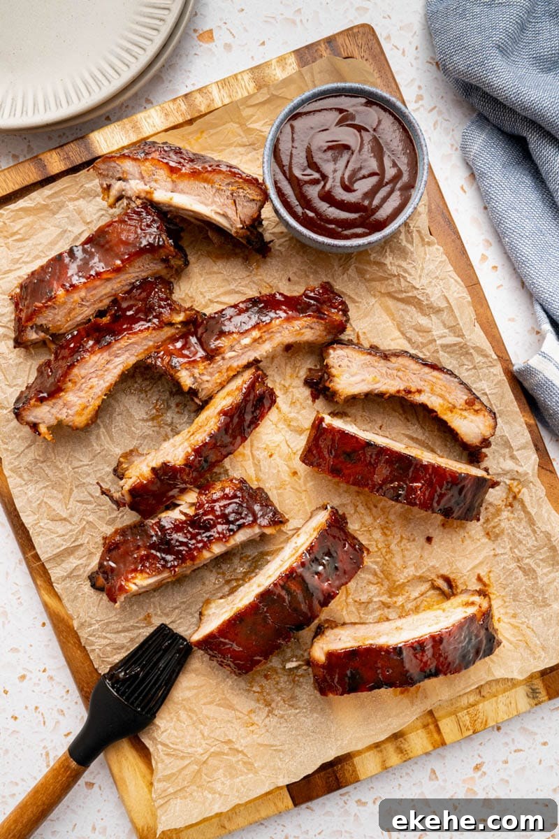 Sliced baked ribs on a wooden cutting board just before serving. 