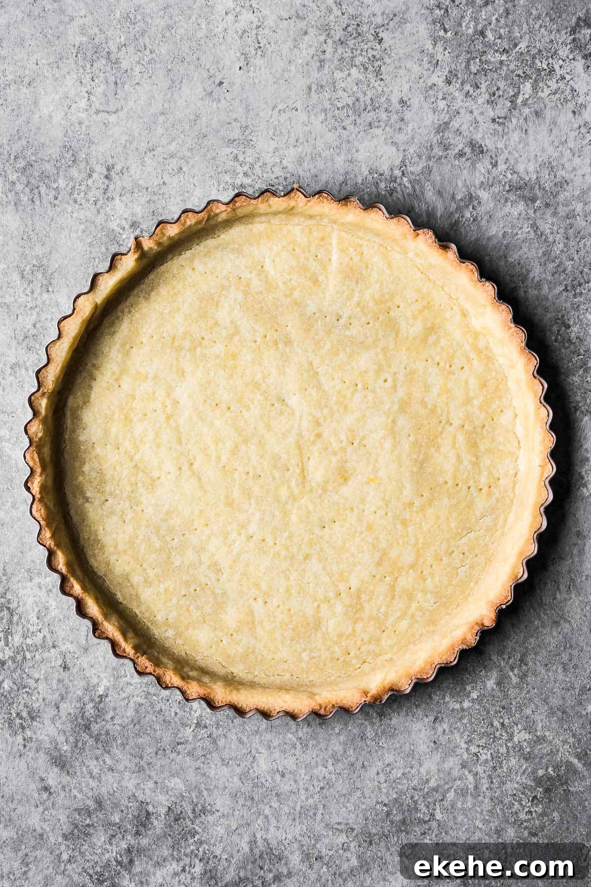 Parbaked pate sucree dough in a round tart pan.