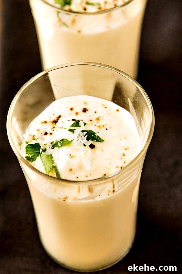 A shot glass of a single serving of brown butter cauliflower soup.