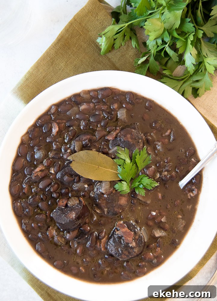 Close up of a white bowl holding a serving of Brazilian black beans