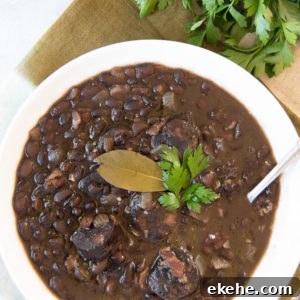 Close up of a white bowl holding a serving of Brazilian black beans