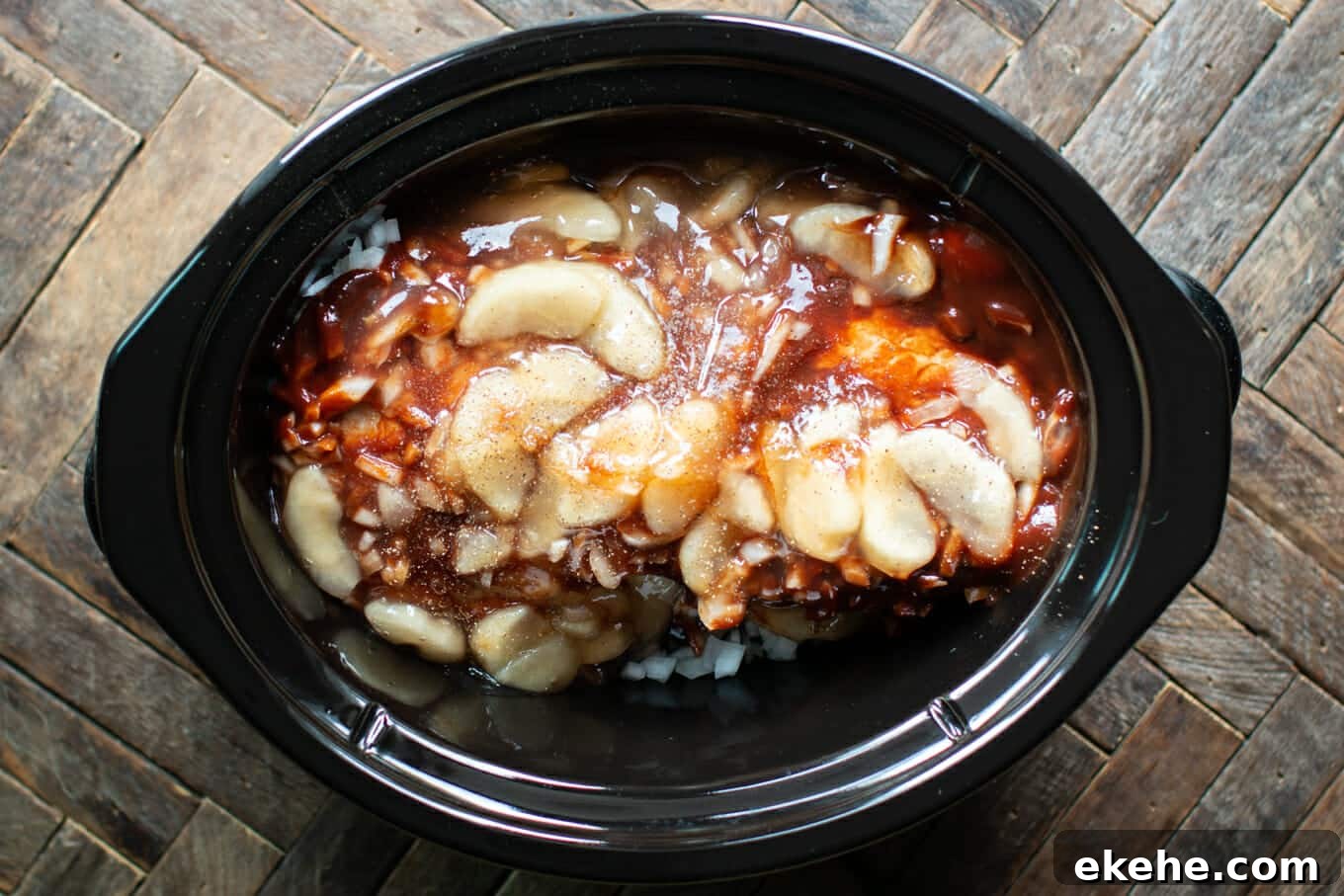 pork loin with onions, barbecue sauce and apple pie filling on top.