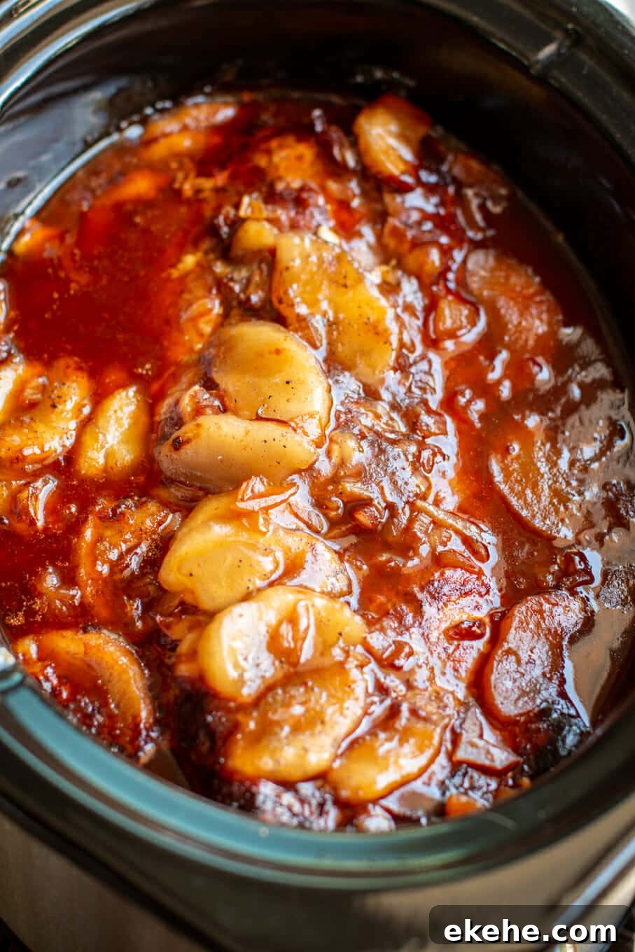 close up of apple barbecue pork loin in slow cooker.