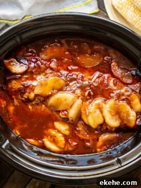pork loin in barbecue sauce with canned apples cooked in slow cooker.