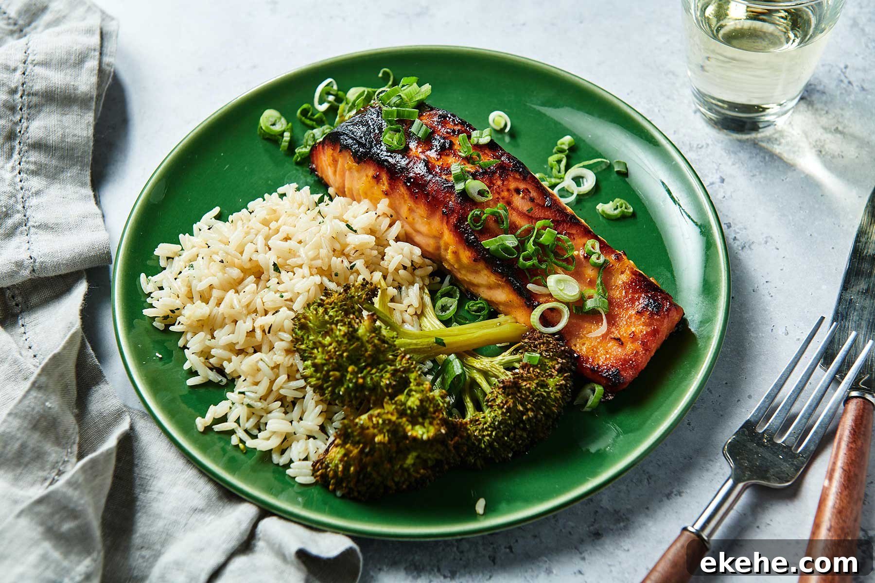 Miso Salmon on a plate with broccoli and rice.