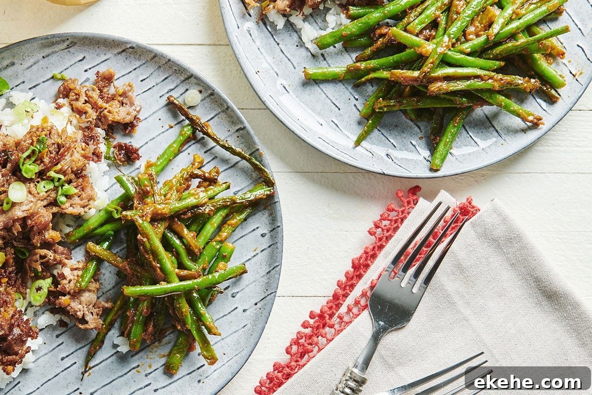 Blistered Green Beans with Miso Butter on grey plates with table setting.