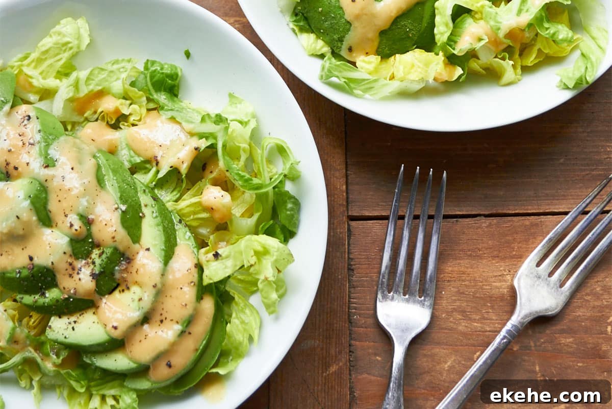 Avocado Salad with Creamy Miso Dressing on white plate.