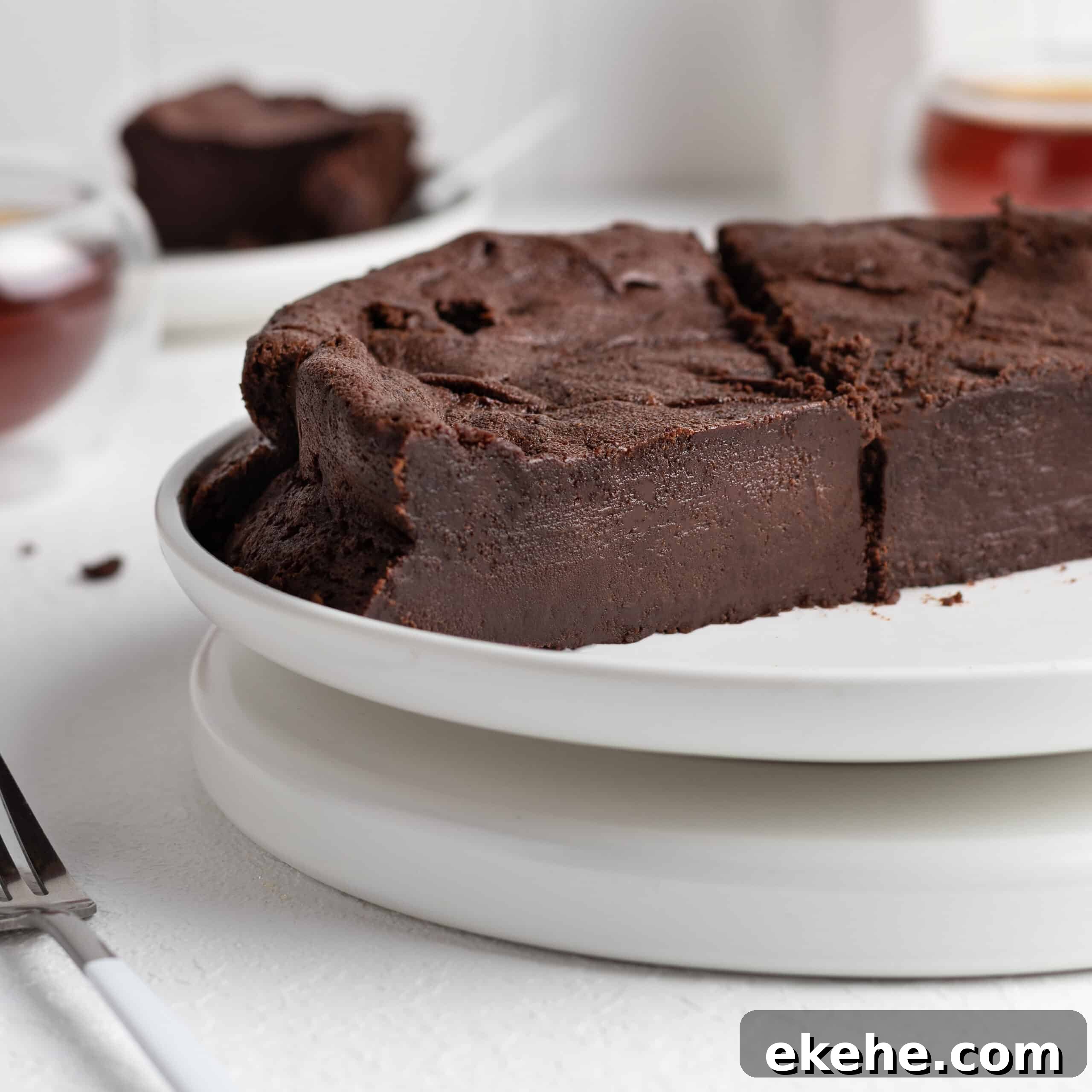 Halved French chocolate fondant cake on a cake stand