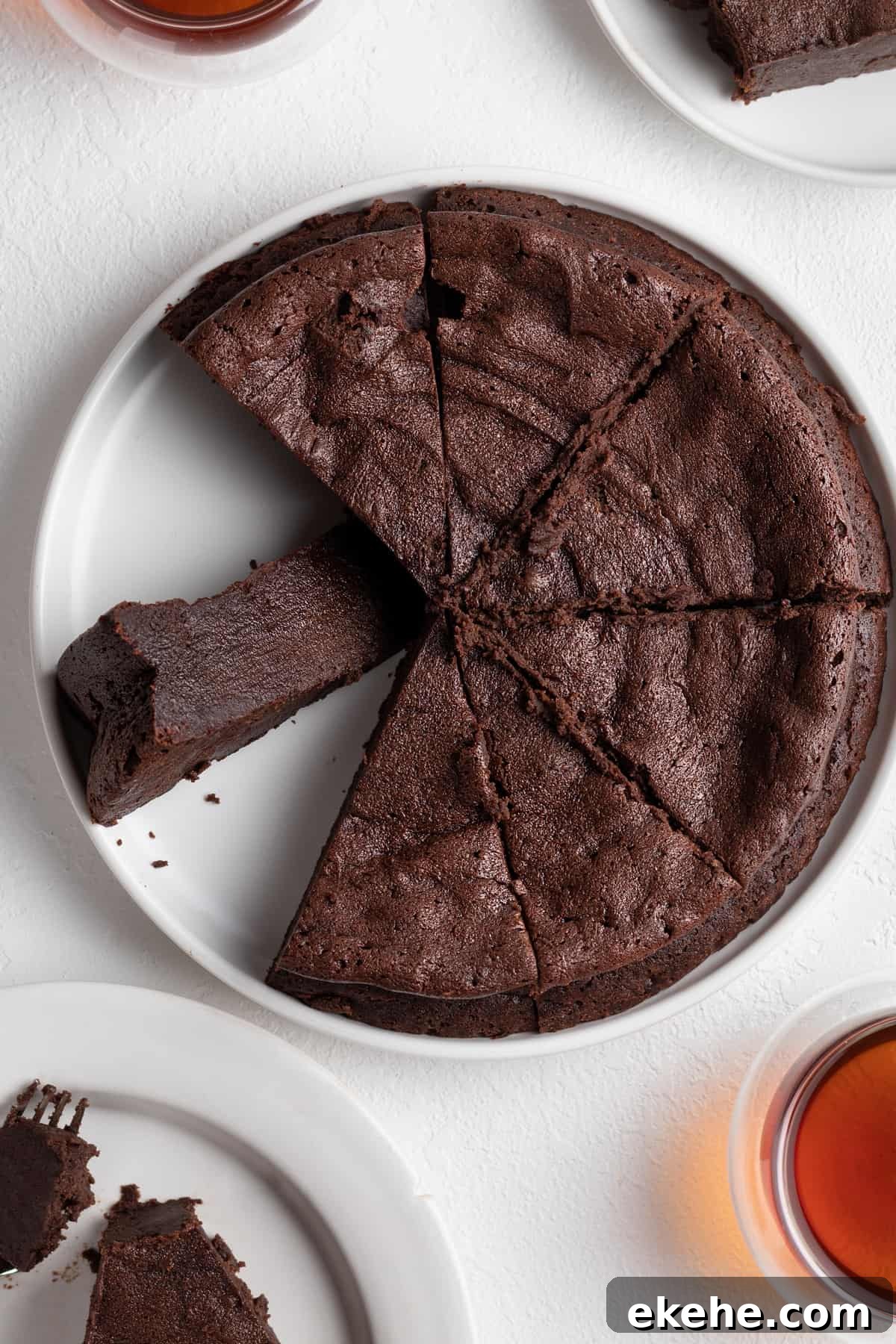 Sliced French chocolate fondant cake on a white serving plate