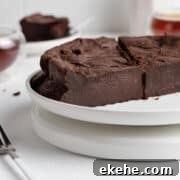 Halved French chocolate fondant cake on a cake stand.