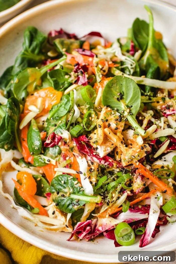 Mandarin Orange Salad recipe with chicken, tossed in an Asian peanut sauce made with almond butter.