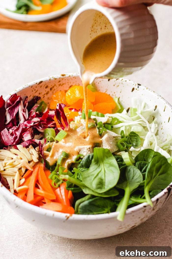 Image to show pouring the peanut salad dressing into a big salad bowl