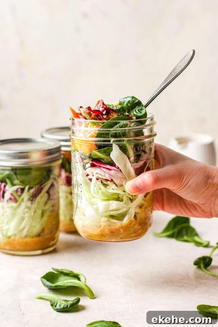 Image shows packing the salad in a big mason jar for portable meal