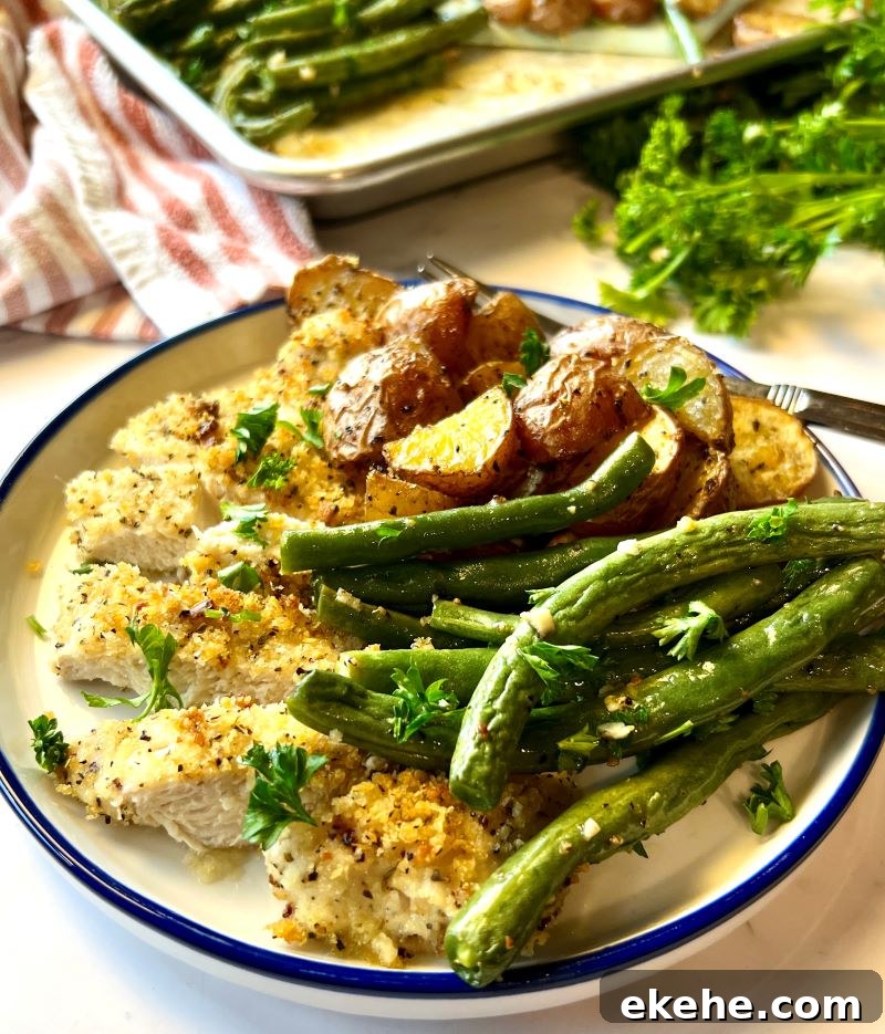 Crispy parmesan chicken sheet pan meal plated.