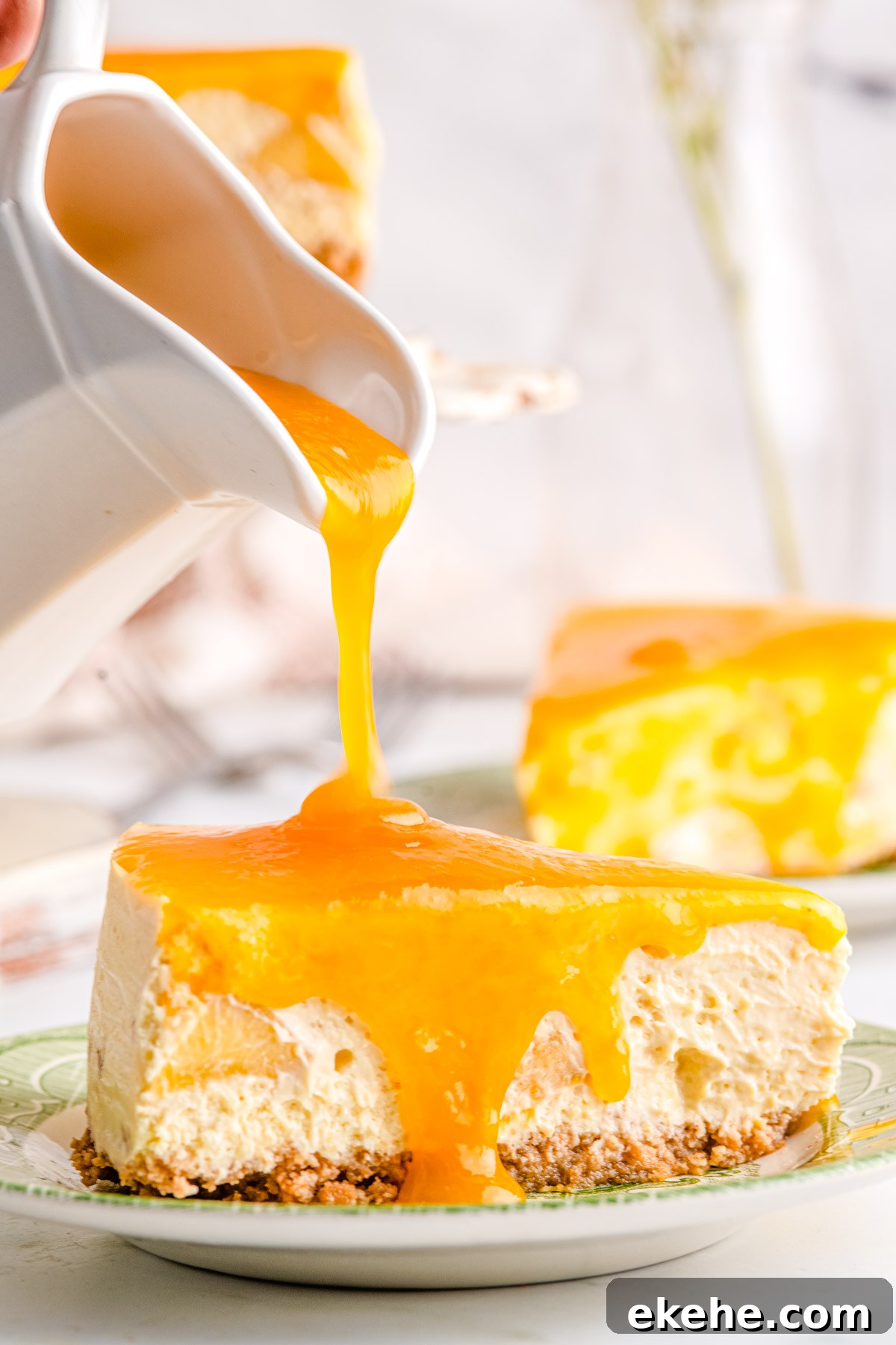 Peach cheesecake topping poured over cheesecake.