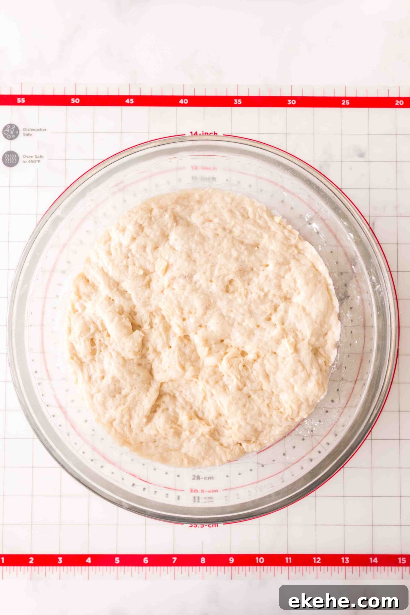 Proofed dough in a large glass bowl. Hostess At Heart