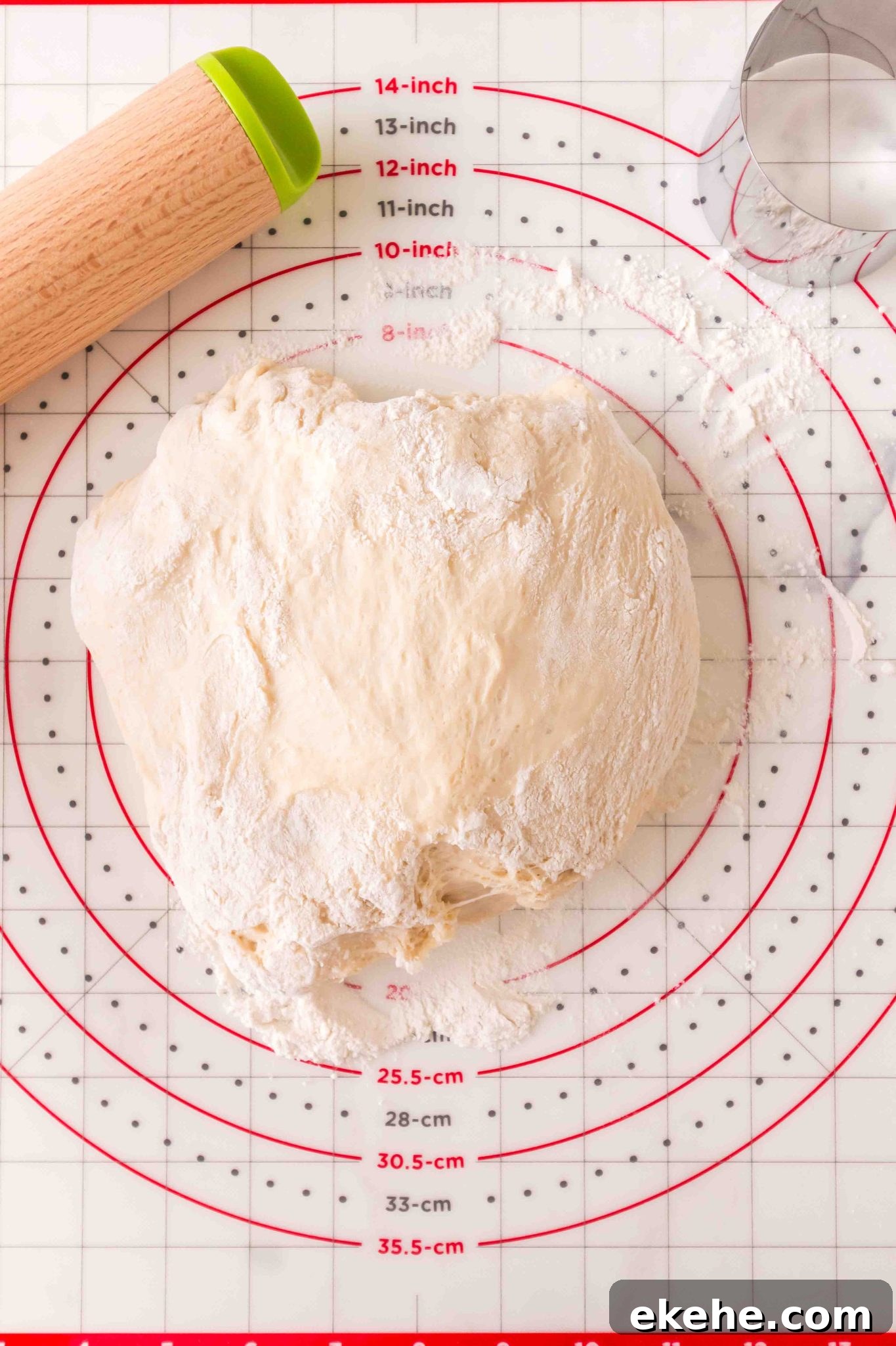 A ball of dough on a floured working surface prepared to roll - Hostess At Heart