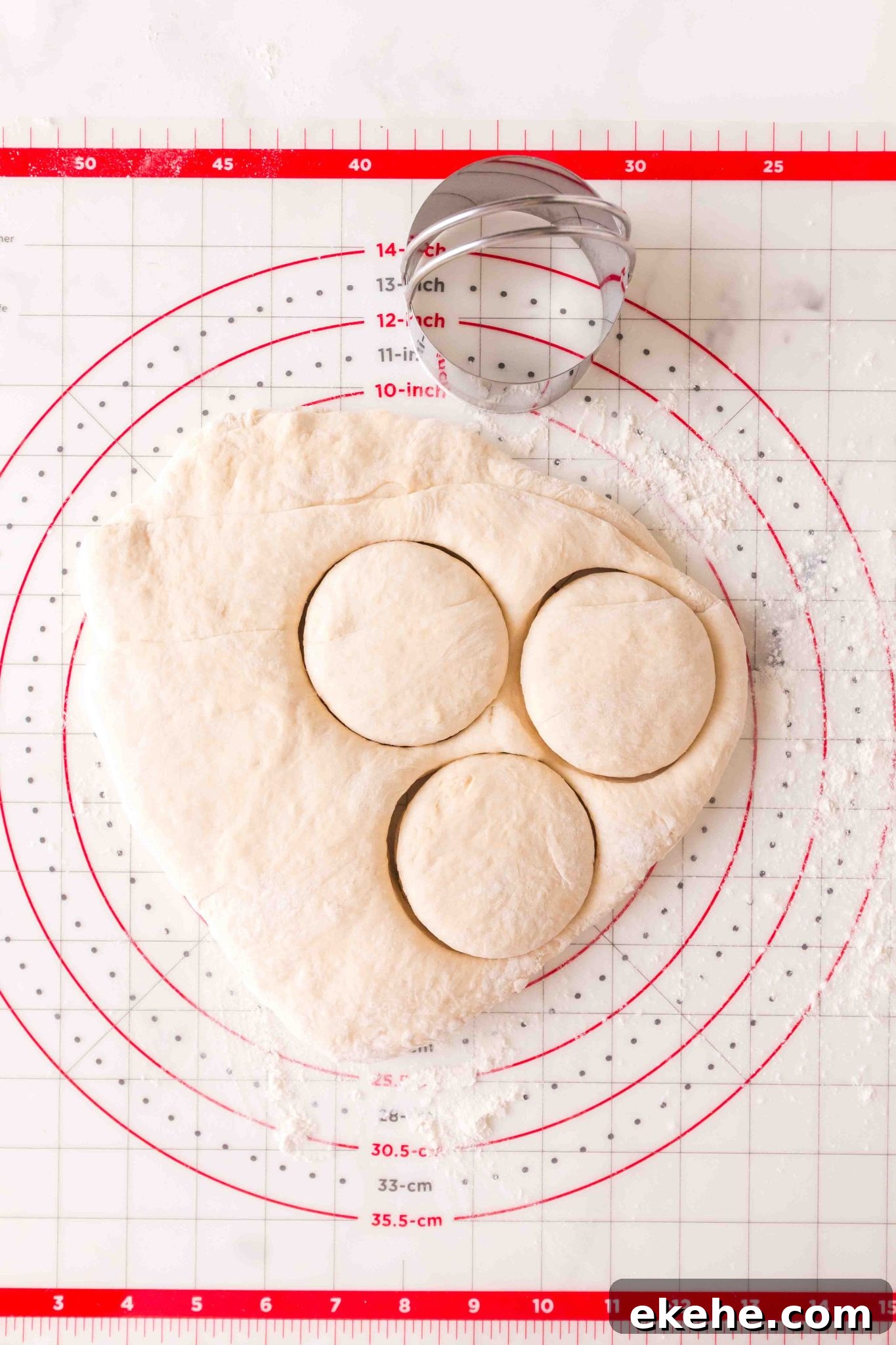 Top down view of English muffin dough being cut. - Hostess At Heart