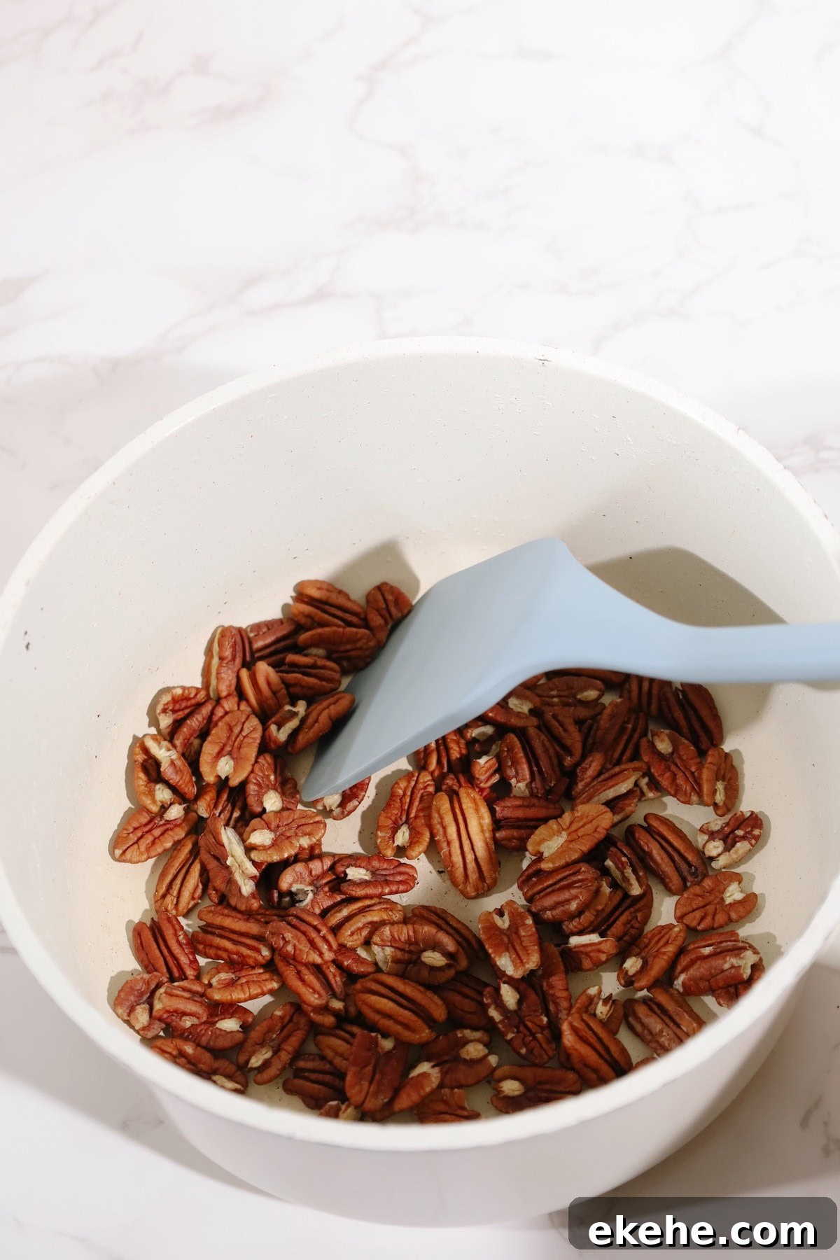 Step one: warm pecans in a skillet.