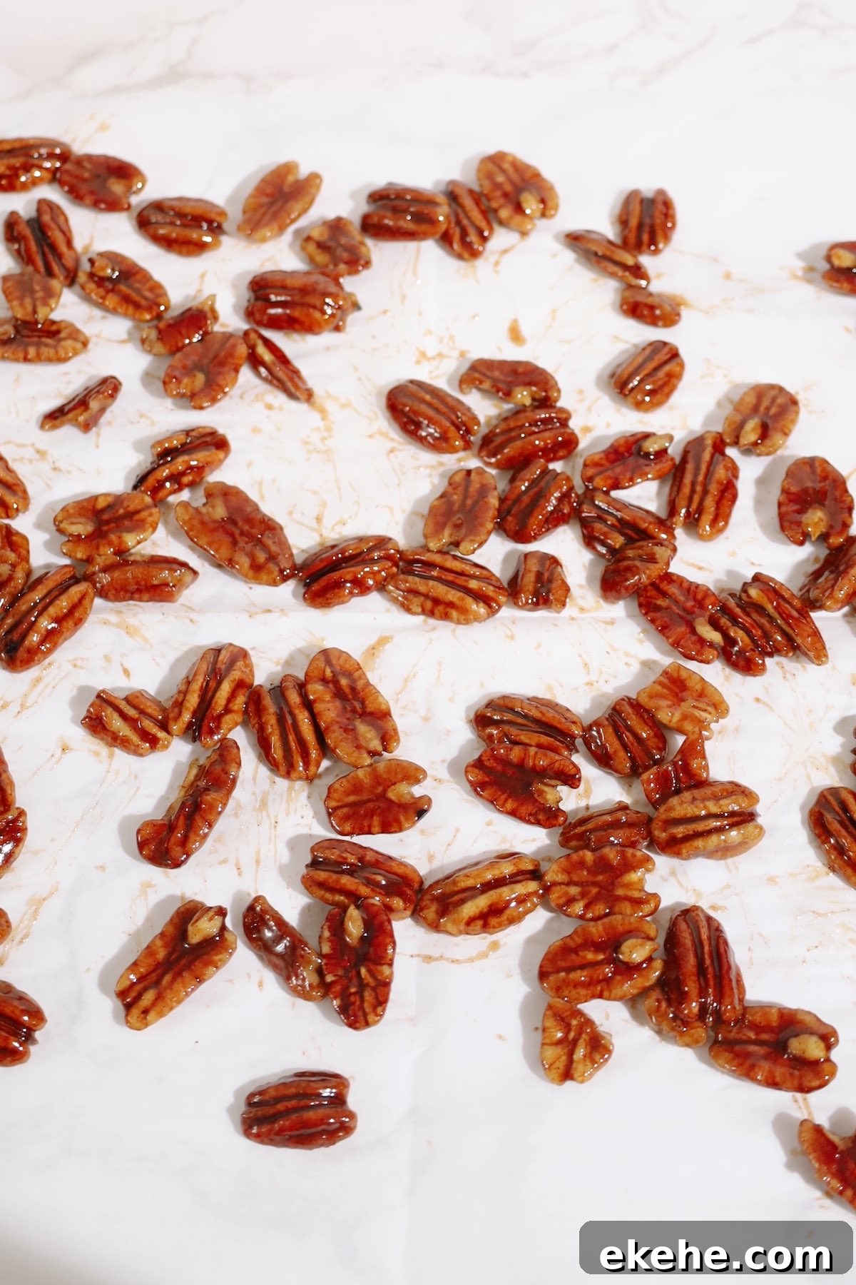Step four: spread the candied pecans on parchment paper.