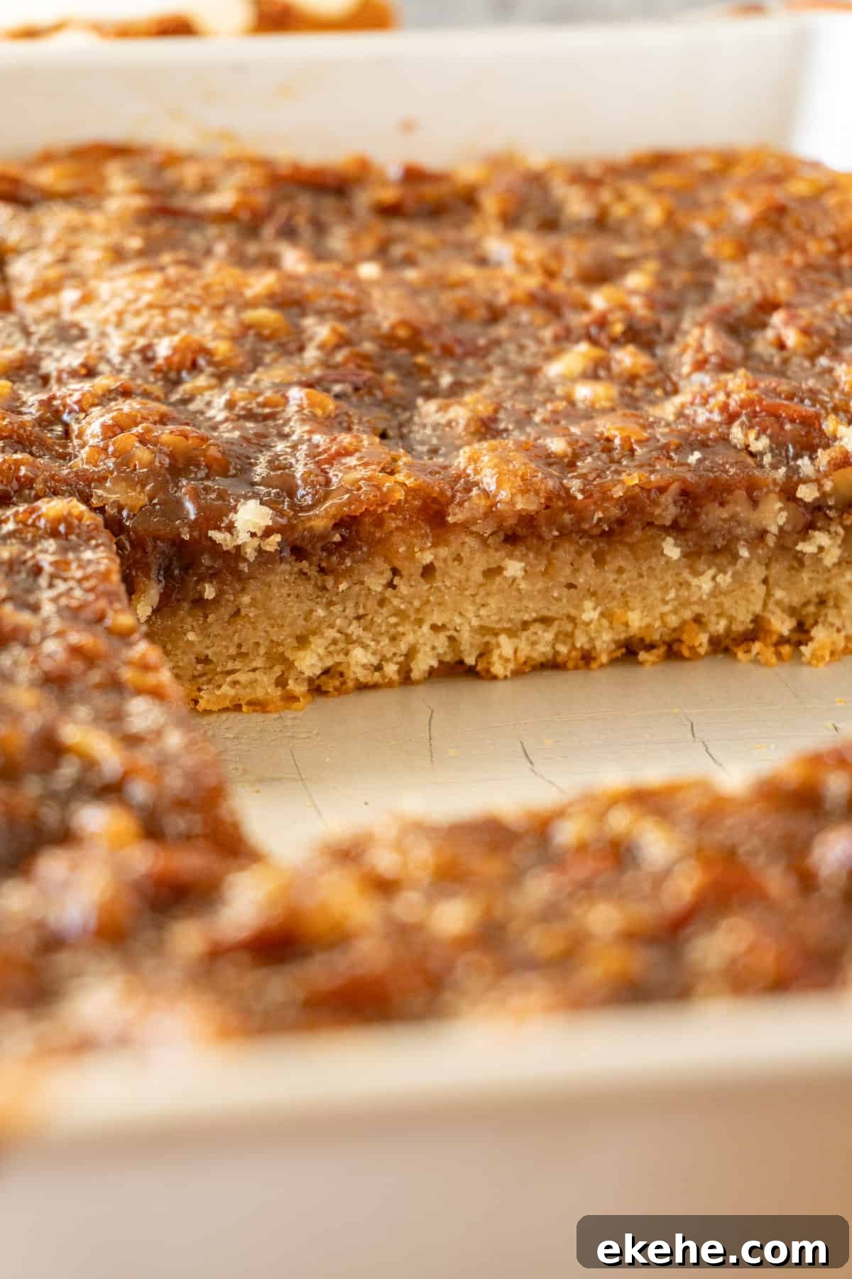 Pecan pie cake in pan with piece missing