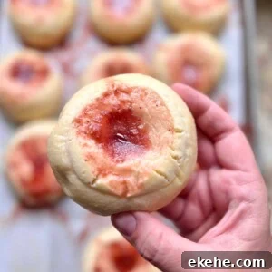 Close-up of a baked sourdough kolache with fruit jam center and cream cheese filling.