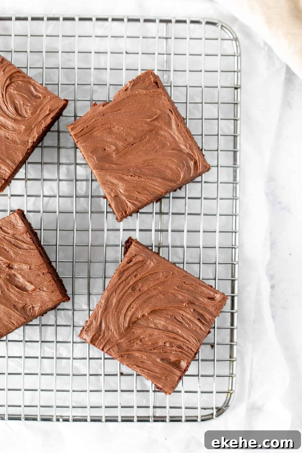 Frosted brownies on a cooling rack