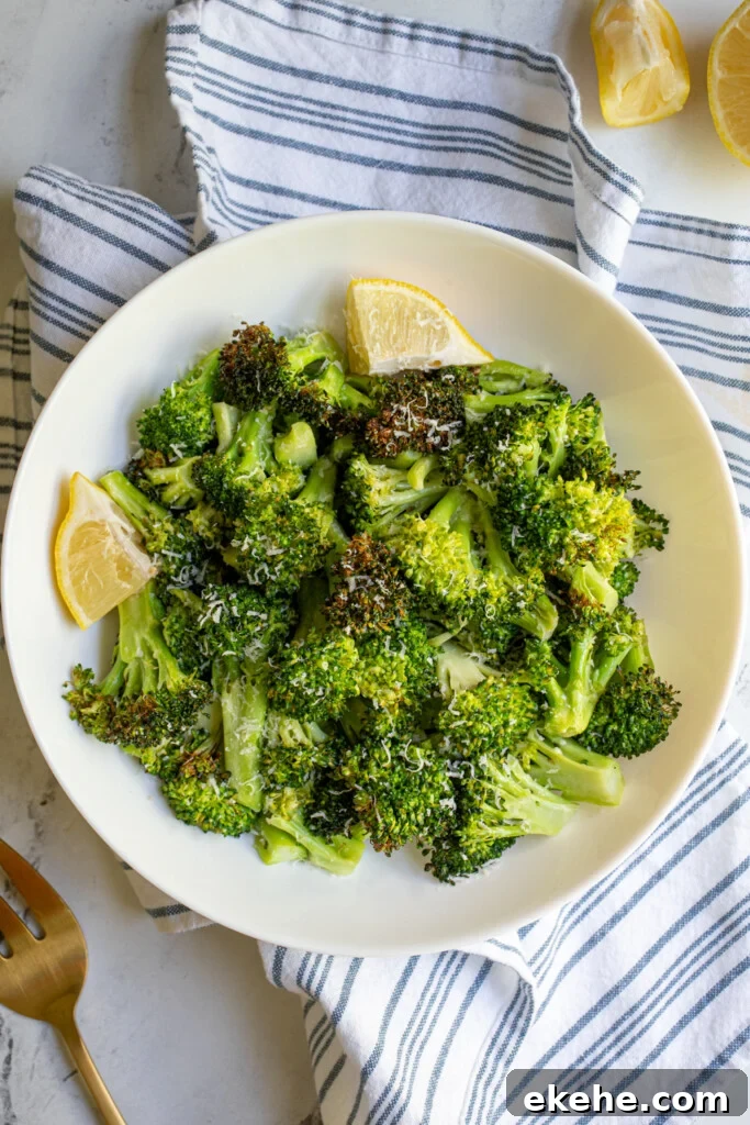 Overhead view of air fryer broccoli in a white bowl.