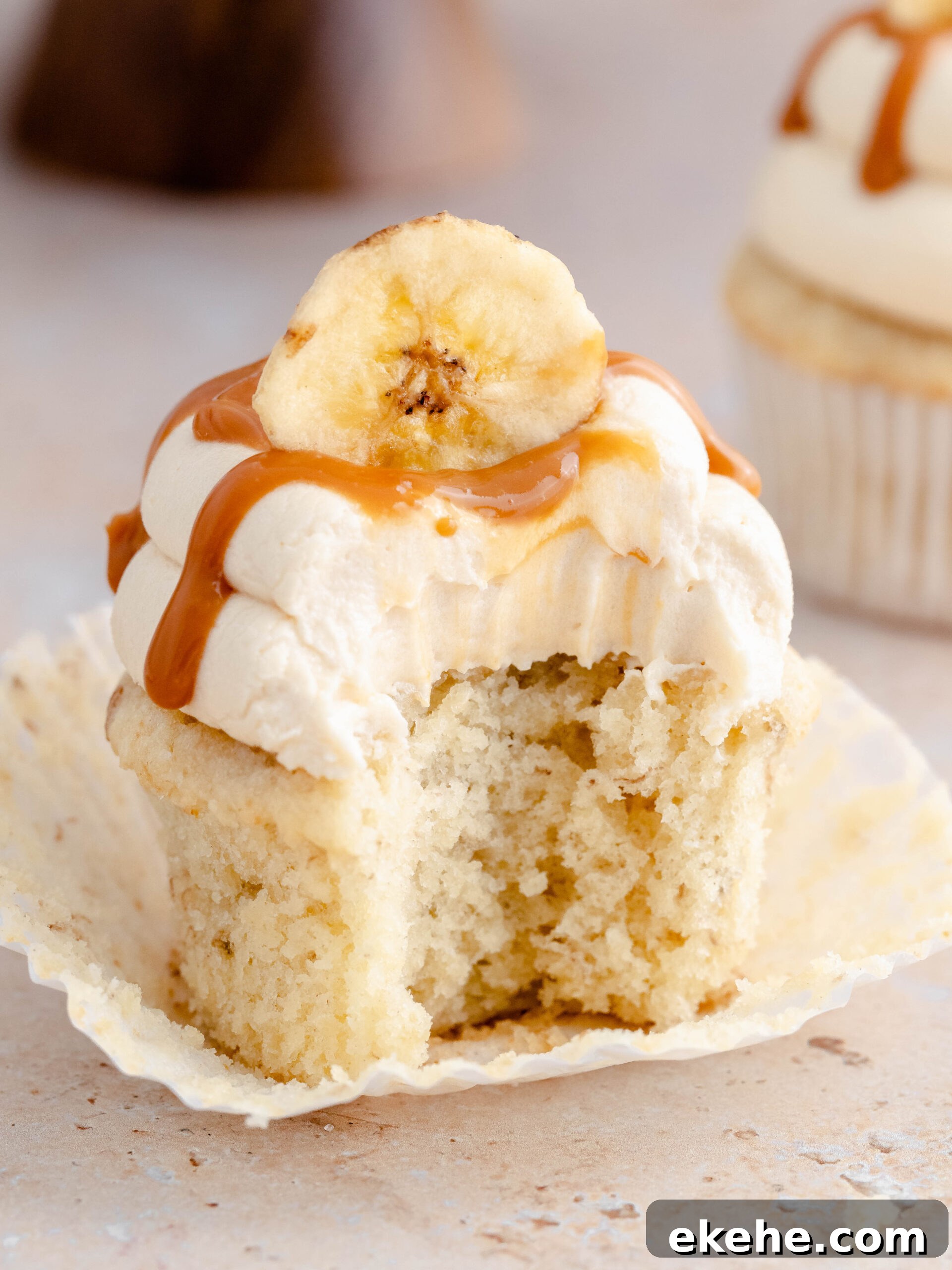 A bite taken of a banoffee cupcake.