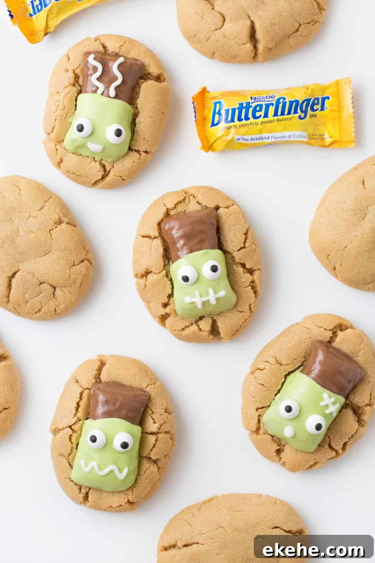 Peanut butter cookies topped with Butterfinger fun size candy bars that have been decorated to look like Frankenstein.