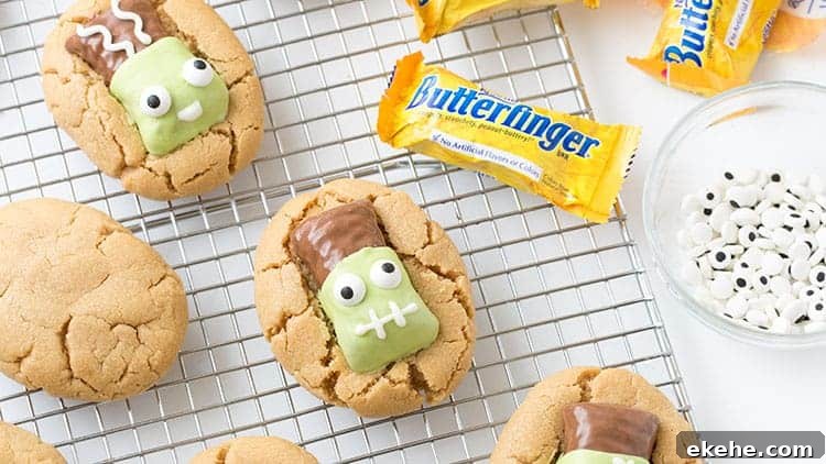 Peanut butter cookies topped with Butterfinger fun size candy bars that have been decorated to look like Frankenstein.