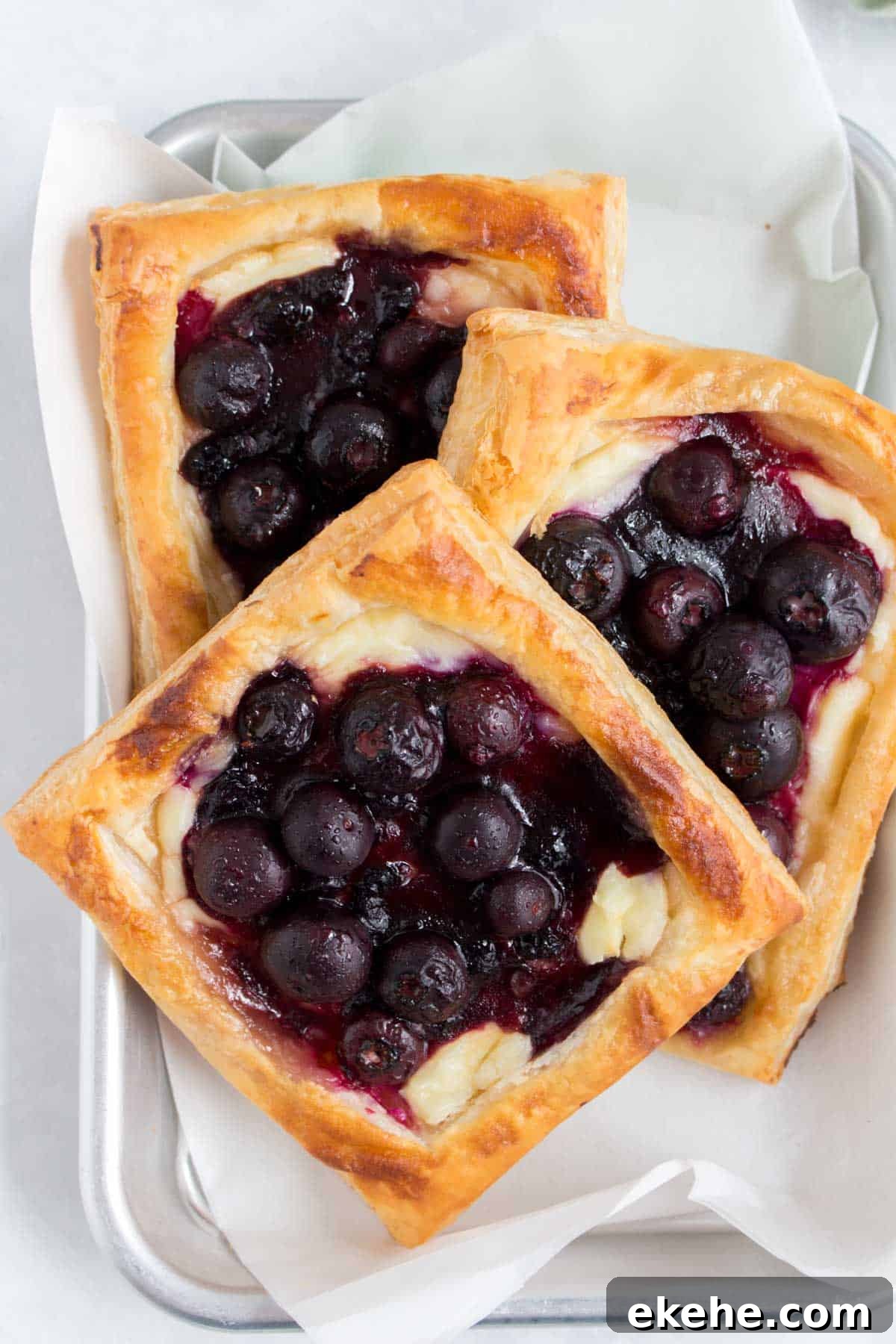 A tray with three cheese danishes.
