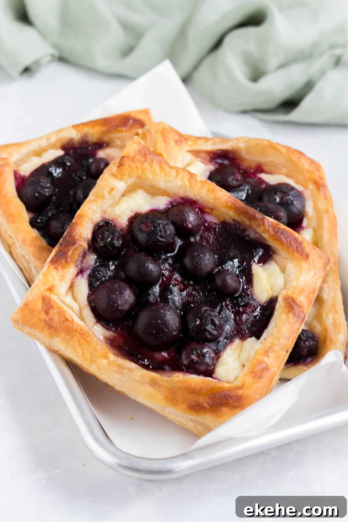 A tray of blueberry cheese danishes.