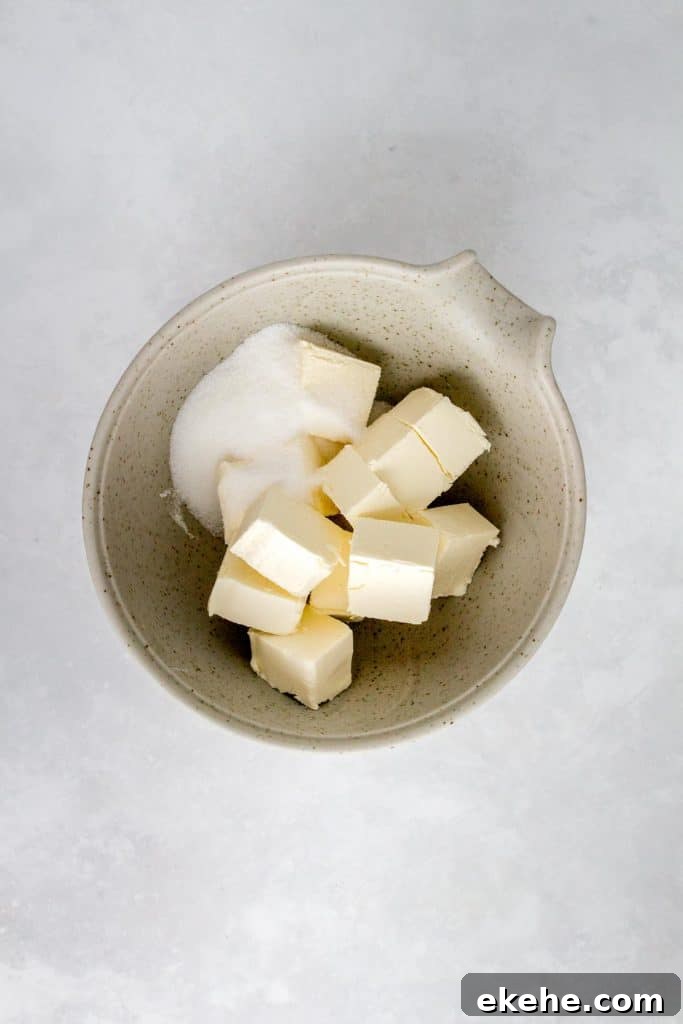 Cream cheese and sugar in a bowl.
