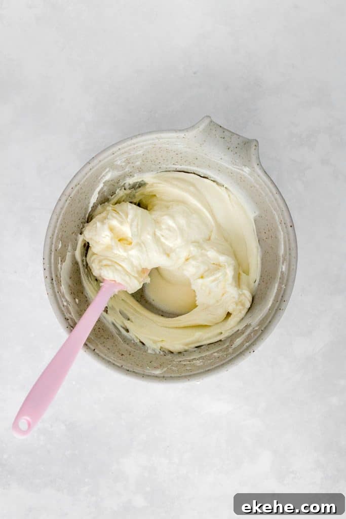 A bowl of cream cheese mixed with sugar.